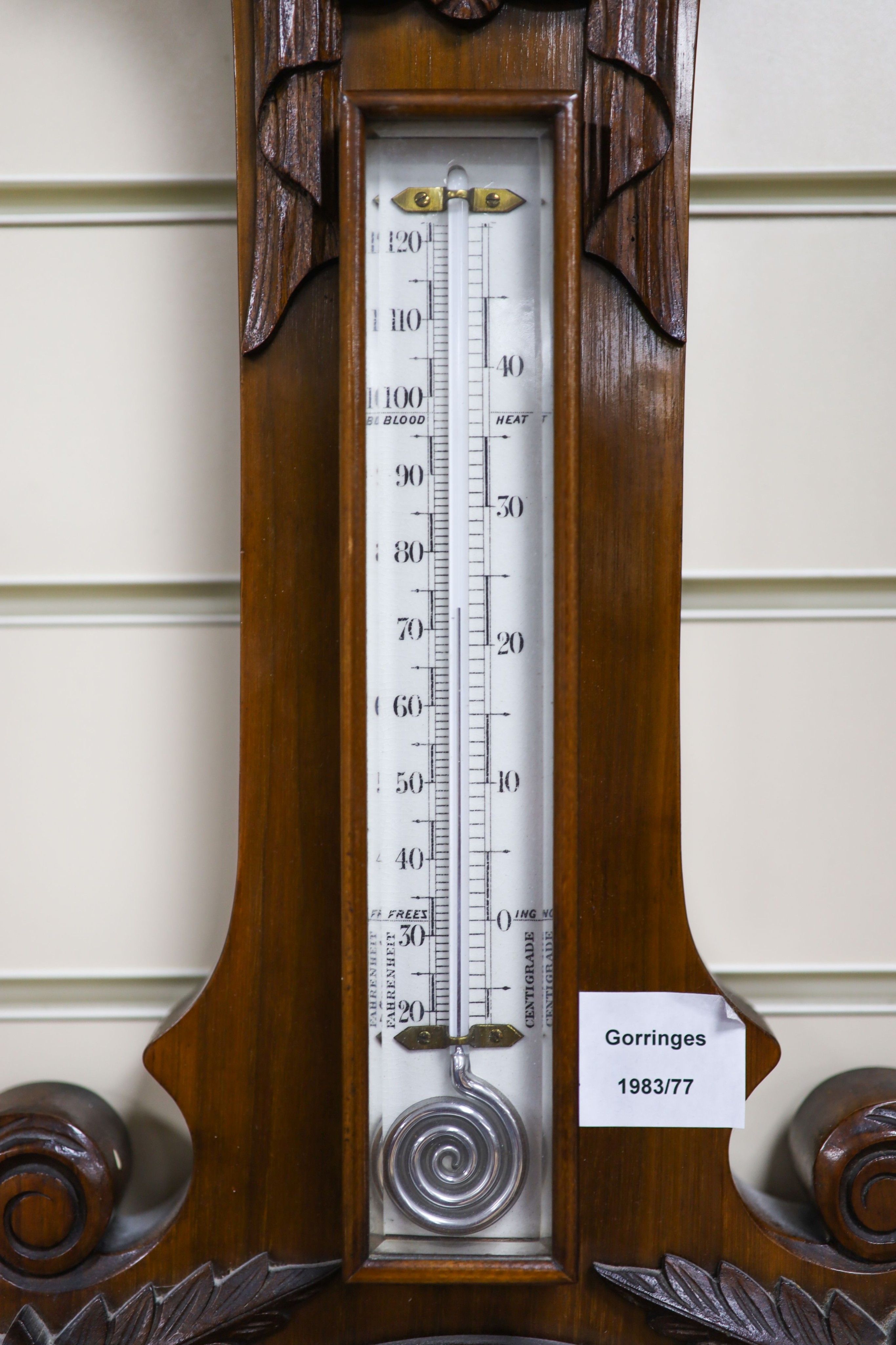 An Edwardian carved walnut cased aneroid barometer and thermometer, height 99cm